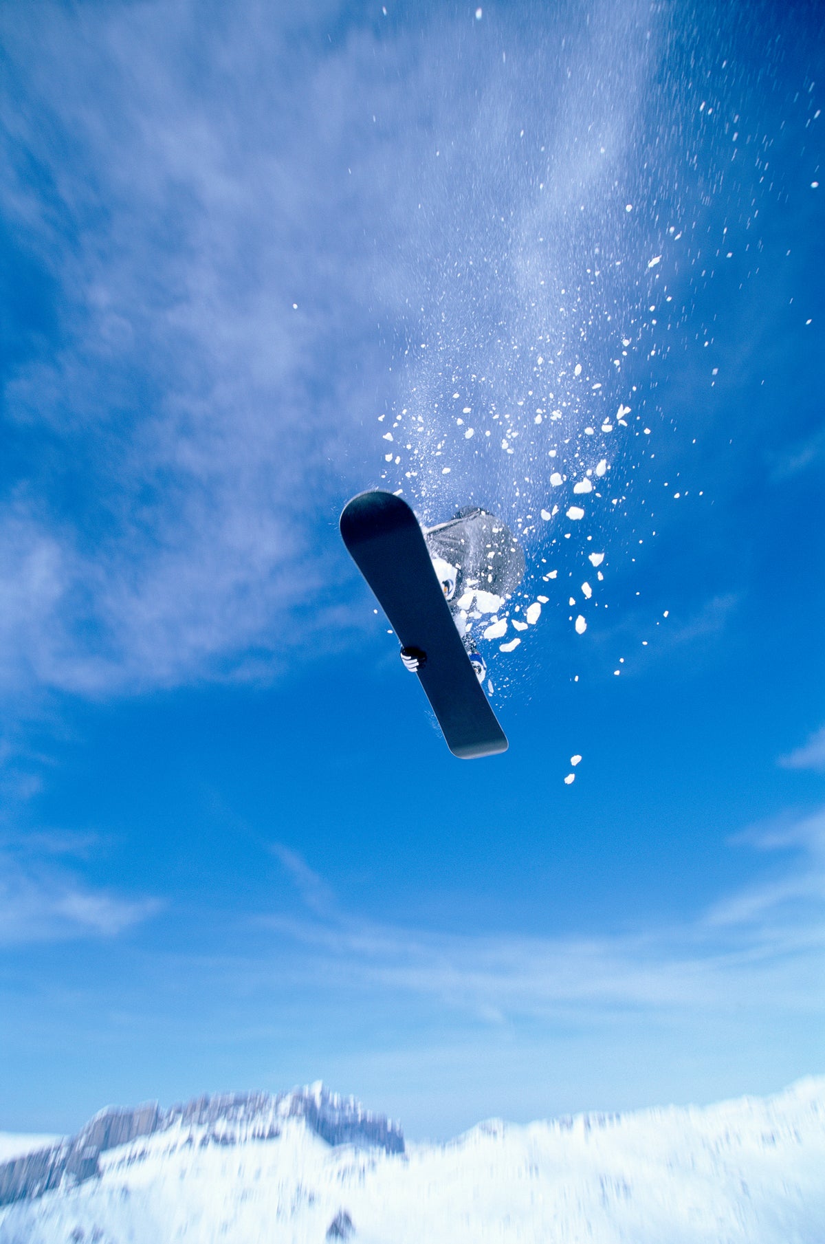 Riderless snowboard tumbling through the air after a fall